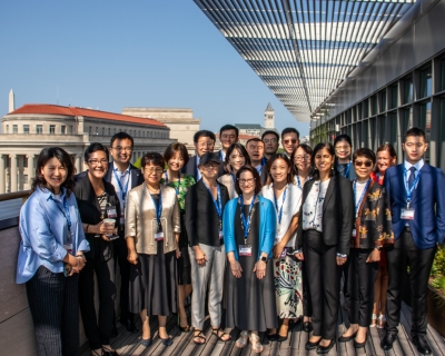 A group of people stand together on the patio of a Washington, D.C., office building.