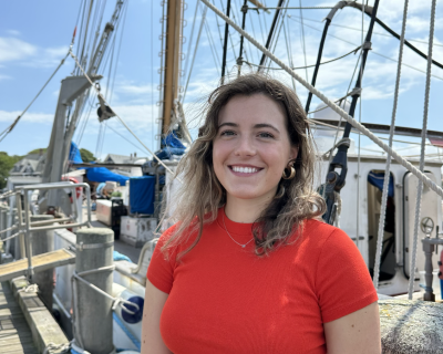 Young woman wearing red t-shirt standing on a large boat