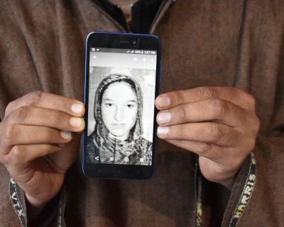 Javed Ahmed Padroo displays a photo of his wife, Ruqiya Javed, on his cellphone. Anantnag, Kashmir, April 21. 