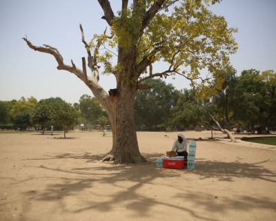 A man takes rest from selling water bottles on a hot afternoon near India Gate in Delhi. 