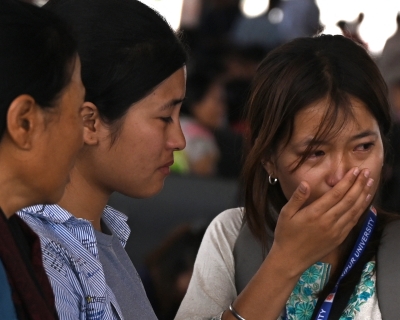 A woman cries as she waits at the Imphal airport to flee ethnic violence in the northeastern Indian state of Manipur on May 7, 2023. 