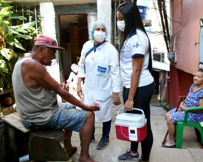 Health workers talk to residents in Rio de Janeiro, Brazil.