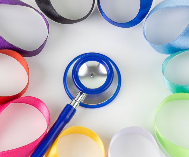 Several different color ribbons are arranged around a stethoscope