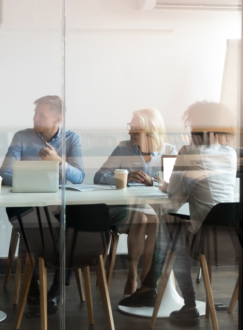 group-of-people-meeting-in-glass-walled-room-gettyimages-1127397327.jpeg