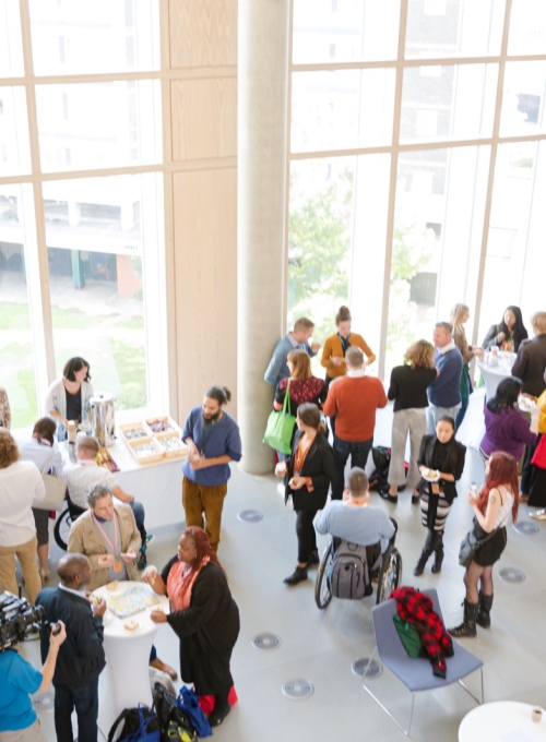 Image of people mingling before/after a meeting