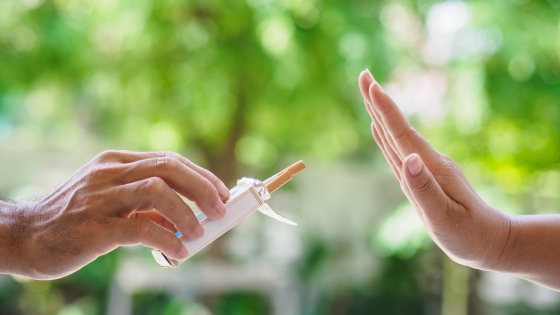 A person declines a cigarette they are being offered.