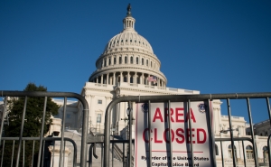 Gates surrounding the United States Capital building with a sign that reads area closed