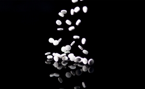 Ketamine pills fall onto a table.