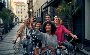 photo of young adults on bikes taking a selfie