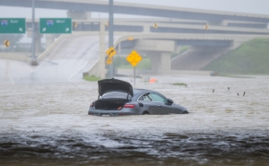 A vehicle is left abandoned in floodwater on a highway after Hurricane Beryl swept through the area on July 8, 2024, in Houston, Texas.