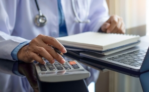 torso showing medical person using a calculator