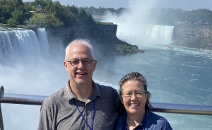 Eileen McDonald and husband David on a boat with Niagara Falls in the background