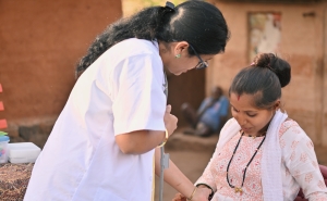 Community health worker conducting a routine examination and providing prenatal care in rural India