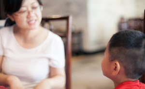 A woman and young boy speaking to each other 