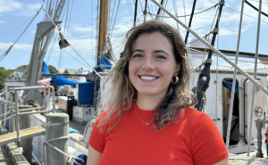 Young woman wearing red t-shirt standing on a large boat