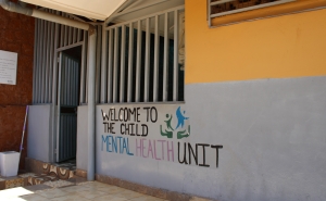Yellow and gray building with the words &amp;quot;welcome to the mental health unit&amp;quot; painted on them.