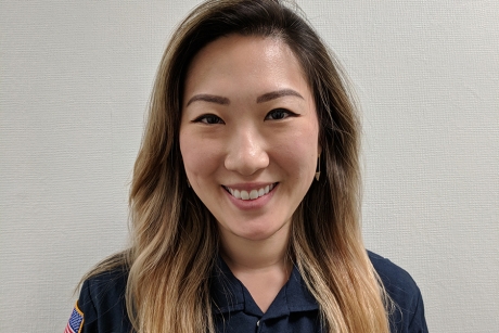 Young woman with long hair in a blue work uniform