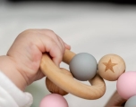 Baby hand grasping wooden toys