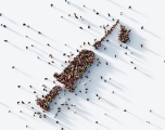 Aerial view of thousands of people forming shape of an injector