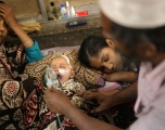 A baby who is suffering from respiratory disease receives treatment inside at Dhaka Shishu Hospital in Dhaka, Bangladesh, February 24, 2021. Syed Mahamudur Rahman/NurPhoto via Getty Images.