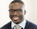 Young African-American man wearing glasses smiling