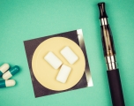 An image of smoking cessation aids, including gum, pills and an e-cigarette.