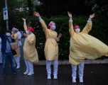 Several health care workers wearing face masks and yellow protective suits acknowledge applause outside the Hospital de Barcelona on April 13, 2020 in Barcelona, during a national lockdown to prevent the spread of the COVID-19 disease. 