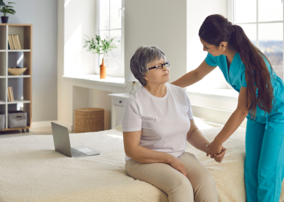 Nurse talking to a woman who is sitting on a bed
