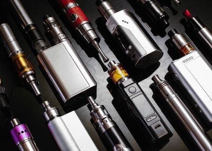 A collection of e-cigarette devices on a black background