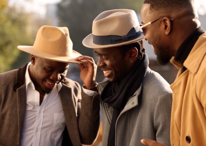 Three Black men smiling