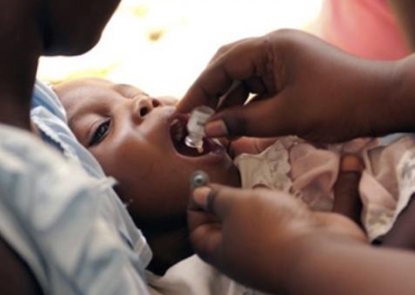 A Haitian child receives oral cholera vaccine during a campaign that successfully reached over 40,000 people during the cholera outbreak in 2012.
