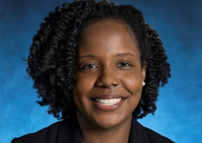 Dr. Risha Irvin smiles for a professional photo.