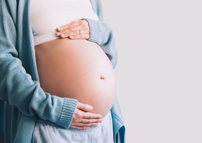 woman holding pregnant belly